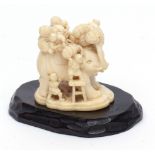 Japanese ivory okimono finely carved with seven boys loading provisions onto a trumpeting