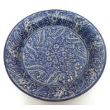 19th century Persian blue glazed pottery large dish, all over decorated with a floral and foliate