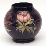 Moorcroft circular baluster vase, decorated in the "Anemone" pattern to a cobalt blue ground,