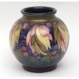 Large William Moorcroft baluster vase decorated with the "Leaf and Berry" pattern, blue painted