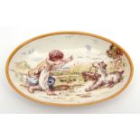 Small Wedgwood oval dish painted and signed by Emile Lessore featuring a boy playing with a dog,