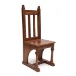 Late 19th century/early 20th century light oak high back chapel chair with moulded cresting rail and