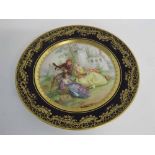 Dresden decorative cabinet plate with blue and gilded rim and painted centre of a musician and two