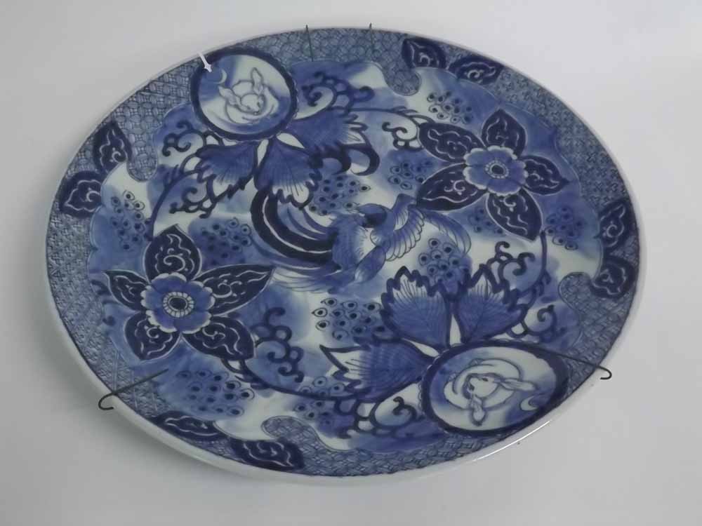 19th century Chinese blue and white charger with a central bird among flowers with two circular