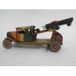 British made tin plate clockwork artillery truck with mounted gun to reverse, with two soldiers,
