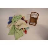 Box containing vintage dolls clothing and a wicker dolls chair