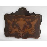Wall mounted poker work pocket with detail of two winged gryphons with central shield, 41cms wide