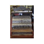 Good quality Michigan cast cash register with a scrolling design and shaped sign to top stating "