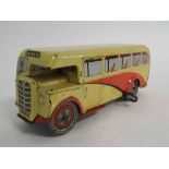 British made tin plate clockwork private bus, painted in cream and red (unboxed), 19cms long