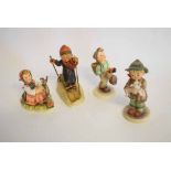 Four Hummel Goebel figures to include a boy skiing, a boy going for a stroll with a basket on his