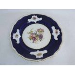 Doulton Burslem painted plate with blue ground, with central painted flowers and gilded rim, 26cms