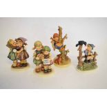 Mixed Lot: four Hummel Goebel figures to include a young girl seated in a tree with a dog at foot, a