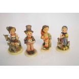 Four Hummel Goebel figures to include a young boy with a goat, a choirboy with a top hat, young