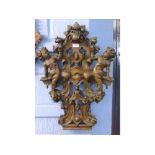 Good quality painted fibre-glass wall hanging of two putti seated on an open work lozenge, 48cms