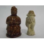 Salt glazed money box formed as a seated figure with a jug, together with a further salt glaze