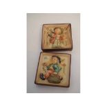 Two framed Hummel Goebel square wall plaques with raised figures of a young boy with a violin and