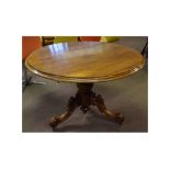 Mahogany framed circular topped breakfast table with turned column on a carved scrolling tripod