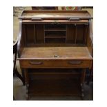 Early 20th century oak framed small tambour fronted desk with open pigeonholed interior, fitted with