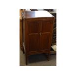 Edwardian mahogany music cupboard fitted with two panelled doors with eight enclosed fixed