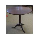 Georgian mahogany circular top tilt top table with turned column, supported on a tripod base,