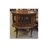 Eastern hardwood oval display cabinet with panelled glass fitted with two doors and cabriole legs,