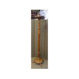 Edwardian oak framed coat rack on a reeded and turned column, on a circular three-footed base,