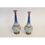 Pair of Doulton Lambeth tall necked vases, with a bulbous body with textured floral decoration and