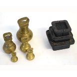 Box containing a graduated set of five brass weights, together with a further cast metal set of