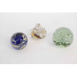 Three assorted paperweights to include a green glazed dump paperweight etc, largest 10cms tall