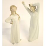Two Lladro figures of a young girl stretching and boy in similar pose, both approx 23cms high, boxes