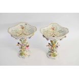 Pair of 19th century Continental porcelain figure and flower encrusted comports with pierced and