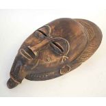 Carved African ceremonial mask of a bearded gent, with a head-dress, 20cms wide x 36cms long