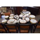 Extensive set of Coalport Newburyport dinner wares with a rust ground and central shield panel of