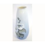 Royal Copenhagen tapering vase decorated with large white flower heads against a light blue backgro