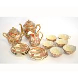 20th century Satsuma part tea set with figural decoration, comprising a teapot, two handled lidded