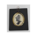 Framed silhouette of a lady by Dorothy Taunton with inscription verso, signed, in an ebonised frame,