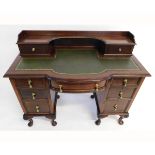 19th century mahogany twin pedestal desk, the top fitted with two drawers with shaped green