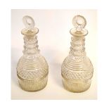 Pair of Georgian four-ringed faceted decanters with matching stoppers, each 25cms tall