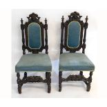 Pair of Victorian oak Gothic hall chairs, heavily carved throughout with reeded columns and a