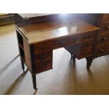 19th century mahogany five-drawer desk with decorative turned knob handles on tapering square legs