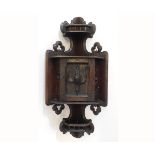 Oak Black Forest type hanging corner cupboard with carved dead game to front, with open spindle