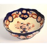 Mason's circular bowl decorated in blue and reds with central vase of flowers, in the Mason Imperial