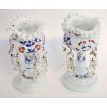 Pair of small opaque glass lustres with red and blue painted floral design, with prismatic drops,