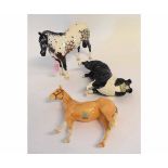 Two Beswick horses to include a Appaloosa horse with a damaged ear, a further tan horse with damaged