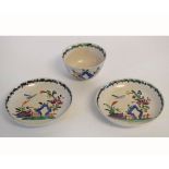 Mid-18th century salt glazed tea bowl with two saucers with a green rim and decorative floral and