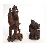 Two 20th century root carved figures of an old sage holding a scroll and the other in a seated