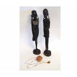 Pair of tall Zulu hardwood carved figures of a boy and a girl, with the boy grasping a spear and a