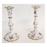 Pair of 19th century enamelled candlesticks with fluted decoration and red sprigs of flowers