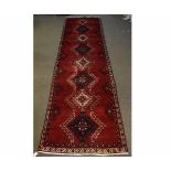 20th century Persian Hamadan runner, cross medallion design to a red ground, 188cms x 92cms