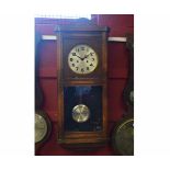 Mid-20th century oak cased 8-day wall clock, the overhanging cornice with shaped pediment to a